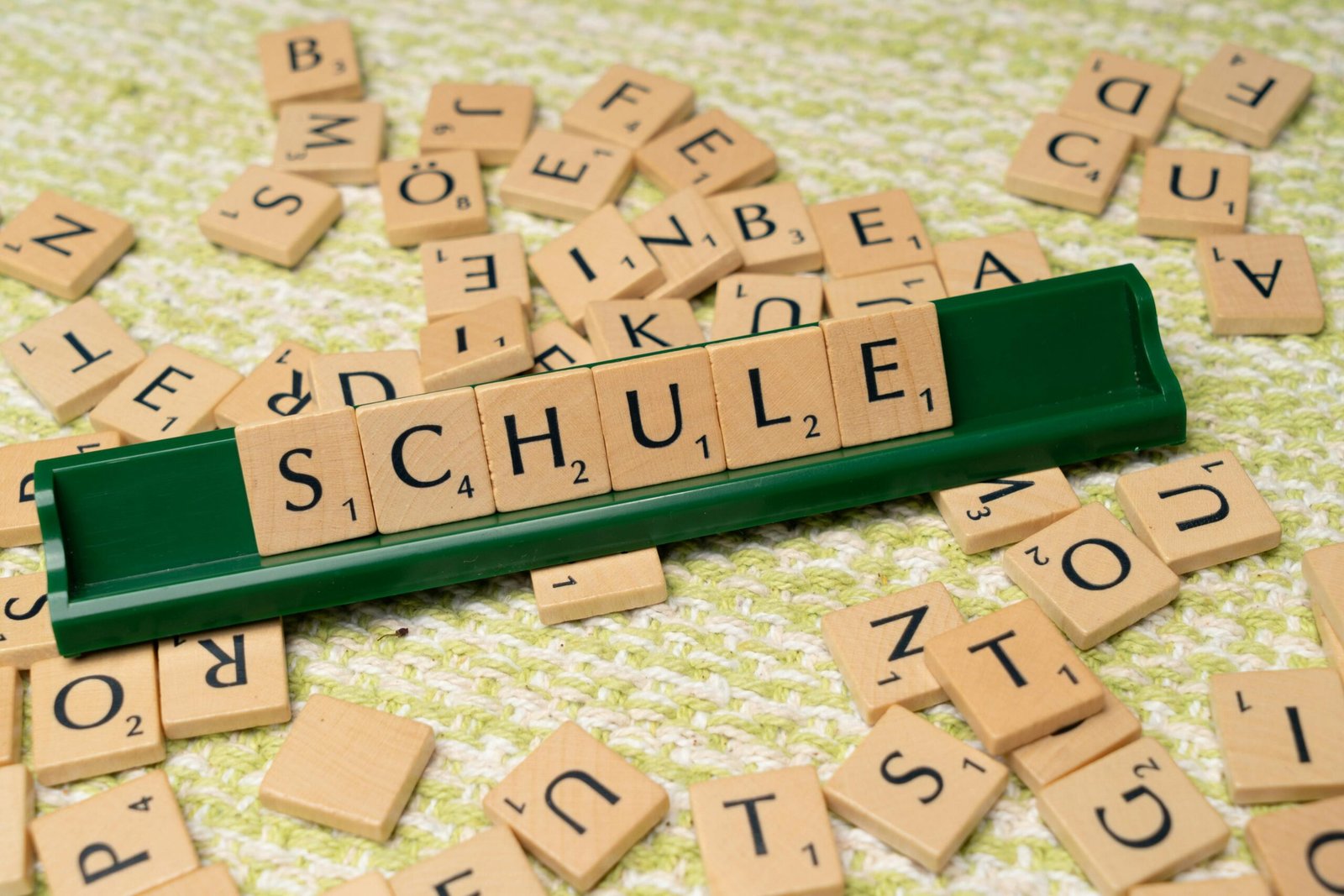 Word tiles spelling 'Schule' on table, ideal for language learning concepts.
